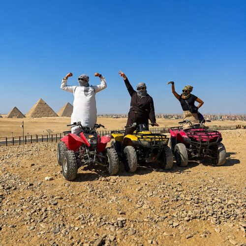 Tourist riding a quad bike in the desert with the Giza Pyramids in the background Quad bike adventure near the Great Pyramids of Giza, Egypt ATV tour through the desert surrounding the Giza Pyramids